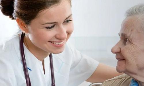 Registered Nurse Smiling with Elderly Patient